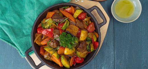 Delicious stir-fried vegetables and beef in a black skillet top view, perfect for colorful cuisine inspiration.
